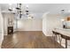 Living room with hardwood floors, fireplace, kitchen access, and bar seating at 723 Renshaw Ct, Cary, NC 27518