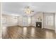 Spacious living room with a fireplace, ceiling fan, and hardwood flooring at 723 Renshaw Ct, Cary, NC 27518