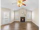 Bright living room featuring hardwood floors, fireplace, and a ceiling fan at 723 Renshaw Ct, Cary, NC 27518
