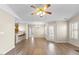 Open concept living room with hardwood floors, a ceiling fan, and natural light at 723 Renshaw Ct, Cary, NC 27518