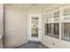 Covered back patio featuring a ceiling fan, door, and shuttered windows at 723 Renshaw Ct, Cary, NC 27518