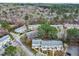 An aerial view shows the layout of the townhome community amid wooded, landscaped surroundings at 7317 Sandy Creek Dr, Raleigh, NC 27615