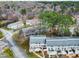An aerial shot displays the layout of townhomes in a community, amidst mature trees and lawns at 7317 Sandy Creek Dr, Raleigh, NC 27615