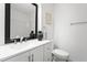 Modern bathroom featuring a white vanity with double sinks and sleek black accents at 7317 Sandy Creek Dr, Raleigh, NC 27615