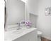 Clean, bright bathroom featuring a vanity with white cabinets, modern faucet, and framed mirror at 7317 Sandy Creek Dr, Raleigh, NC 27615