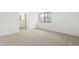 Bright bedroom featuring neutral carpet, large window with scenic view, and ensuite bathroom access at 7317 Sandy Creek Dr, Raleigh, NC 27615