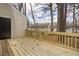 Large wooden deck overlooking a wooded area, offering a private and serene outdoor space at 7317 Sandy Creek Dr, Raleigh, NC 27615