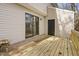 Expansive wooden deck with sliding door and convenient storage access, ideal for outdoor living at 7317 Sandy Creek Dr, Raleigh, NC 27615