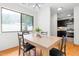 Bright dining area showcases a wood table, black chairs, and a view into the kitchen at 7317 Sandy Creek Dr, Raleigh, NC 27615