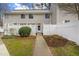 Charming townhouse with a white fence, walkway, and manicured landscaping at 7317 Sandy Creek Dr, Raleigh, NC 27615