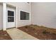 Townhouse entrance featuring a white door, window, and landscaping at 7317 Sandy Creek Dr, Raleigh, NC 27615