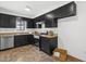 Bright kitchen featuring black cabinets, light countertops, and stainless steel appliances at 7317 Sandy Creek Dr, Raleigh, NC 27615