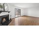 Spacious living room featuring a fireplace and sliding glass doors to the outdoor patio at 7317 Sandy Creek Dr, Raleigh, NC 27615
