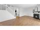 Open-concept living room features a staircase and a fireplace, seamlessly connecting the spaces at 7317 Sandy Creek Dr, Raleigh, NC 27615
