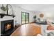 Cozy living room with fireplace, sliding glass doors to the deck, and ample seating at 7317 Sandy Creek Dr, Raleigh, NC 27615
