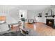 Bright living area with hardwood floors, fireplace, comfortable seating, and staircase at 7317 Sandy Creek Dr, Raleigh, NC 27615