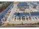 An aerial view of a row of townhomes with solar panels and landscaping, street view, and garage doors at 7802 Flatrock Park Dr # 131, Knightdale, NC 27545