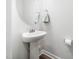 Powder room features a pedestal sink and a round mirror at 7802 Flatrock Park Dr # 131, Knightdale, NC 27545