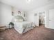 This bedroom offers a calm color palette, large windows, and a beautifully decorated wall for a soothing space at 7802 Flatrock Park Dr # 131, Knightdale, NC 27545
