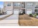 Townhome garages and driveways offering convenient parking, with well-kept landscaping at 7802 Flatrock Park Dr # 131, Knightdale, NC 27545