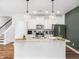 Bright kitchen features an island with granite countertops and stainless steel appliances at 7802 Flatrock Park Dr # 131, Knightdale, NC 27545