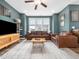 Well-lit living room featuring hardwood floors, a ceiling fan, and a large window with natural light at 7802 Flatrock Park Dr # 131, Knightdale, NC 27545
