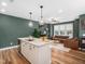 Bright open-concept living space with island kitchen, modern lighting, and hardwood style flooring at 7802 Flatrock Park Dr # 131, Knightdale, NC 27545