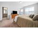 Bedroom with large windows, carpet, and an ensuite bathroom at 7802 Flatrock Park Dr # 131, Knightdale, NC 27545