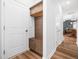 Functional mudroom with built-in storage cabinets, bench seating, and hardwood floors leading to the main rooms at 7802 Flatrock Park Dr # 131, Knightdale, NC 27545