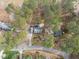The aerial view captures a house with an expansive yard and a forested backdrop, providing a sense of seclusion at 7904 Kingsland Dr, Raleigh, NC 27613
