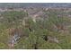 An aerial view reveals a home nestled among lush trees, showcasing the property's privacy and serene setting at 7904 Kingsland Dr, Raleigh, NC 27613