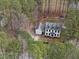 Aerial view highlighting a beautiful home with a large lot surrounded by lush green trees at 7904 Kingsland Dr, Raleigh, NC 27613