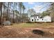 Large backyard with a playset, shed, a deck with stairs, and a white house exterior with black window trim at 7904 Kingsland Dr, Raleigh, NC 27613