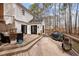 Outdoor deck area featuring patio furniture, stairs to the backyard, a grill, and wooded views at 7904 Kingsland Dr, Raleigh, NC 27613