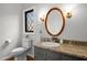 Bathroom featuring granite counters, an oval mirror, sconce lighting, and decorative accents at 7904 Kingsland Dr, Raleigh, NC 27613