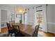 Charming dining room featuring a wooden table, chairs, and modern chandelier, perfect for gatherings at 7904 Kingsland Dr, Raleigh, NC 27613