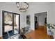 Bright dining area featuring a modern chandelier and glass table with access to outdoor seating at 7904 Kingsland Dr, Raleigh, NC 27613