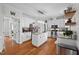 Bright kitchen featuring an island with granite countertops, stainless steel appliances, and hardwood flooring at 7904 Kingsland Dr, Raleigh, NC 27613