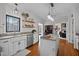 Bright kitchen featuring an island with granite countertops, stainless steel appliances, and hardwood flooring at 7904 Kingsland Dr, Raleigh, NC 27613