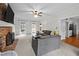 Bright living room with a cozy brick fireplace, neutral carpeting and a ceiling fan at 7904 Kingsland Dr, Raleigh, NC 27613
