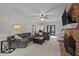 Inviting living room with a cozy brick fireplace, neutral carpeting and a ceiling fan at 7904 Kingsland Dr, Raleigh, NC 27613
