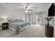 Spacious main bedroom featuring a ceiling fan, carpeting, and natural light from the windows at 7904 Kingsland Dr, Raleigh, NC 27613