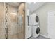 Bathroom featuring glass shower, modern fixtures, and convenient washer dryer combo at 809 Handel Ln, Apex, NC 27502