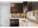 Updated kitchen featuring granite counters, stainless steel sink, and modern backsplash at 809 Handel Ln, Apex, NC 27502