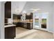Modern kitchen featuring dark cabinets, stone countertops and access to the pool at 809 Handel Ln, Apex, NC 27502