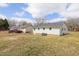 Expansive backyard featuring well-maintained lawn and a detached deck at 825 Parkwood St, Burlington, NC 27215