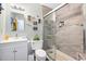 The bathroom features modern tiling in shower, sink, vanity, and updated fixtures at 825 Parkwood St, Burlington, NC 27215