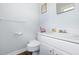 Well-lit half bathroom with a white vanity and a matching toilet at 825 Parkwood St, Burlington, NC 27215
