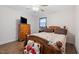 Cozy bedroom features a full-sized bed, dresser, updated floors and ceiling fan with lights at 825 Parkwood St, Burlington, NC 27215
