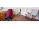 Well-lit room featuring updated floors and space for a home office or reading area at 825 Parkwood St, Burlington, NC 27215